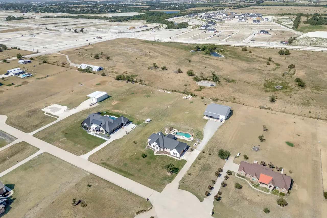 Aerial view of the home, its lot, and the neighboring properties