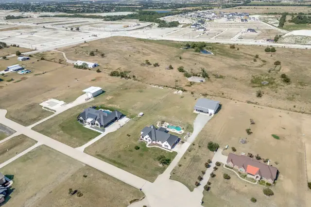 Aerial view of the surrounding area and open land