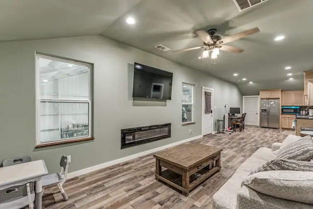 Living area of the guest apartment with a sofa, coffee table, and television