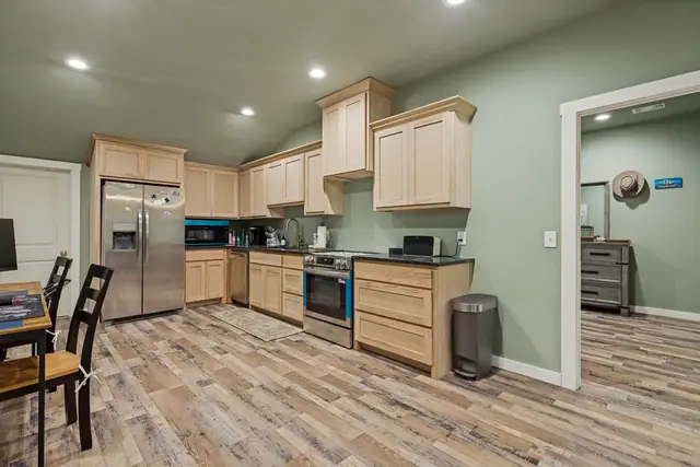 Kitchen in the guest apartment with a refrigerator, range, and dining table