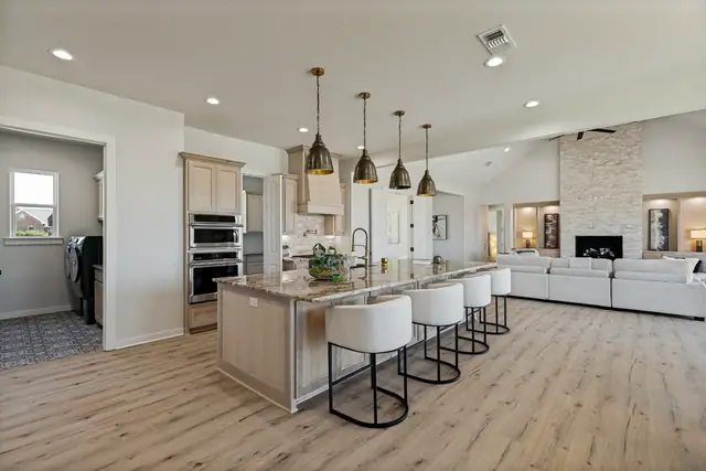 View from the kitchen island across the open living area and fireplace